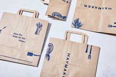 four brown bags with blue designs on them sitting next to each other and one has a fork