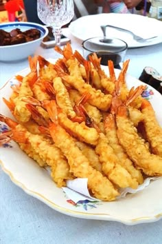 some shrimp sticks are on a white plate