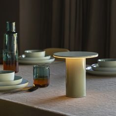 the table is set with plates, cups and saucers for dinner guests to enjoy