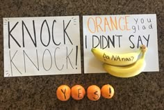 oranges and bananas are on the counter next to signs that say knock, i didn't say yes