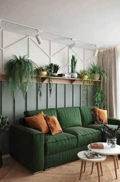 a living room with green couches and potted plants