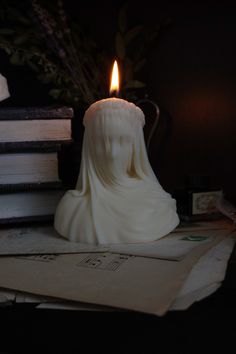 a candle that is sitting on some books