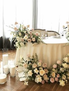 a table with flowers and candles on it