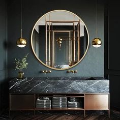 a bathroom with a marble counter top and gold accents on the mirror, along with two hanging lights