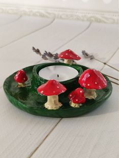 a candle holder with three mushrooms on it