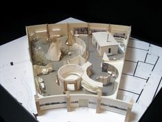 an aerial view of a model house on top of blueprints