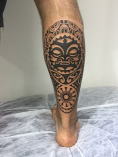 a man's leg with an intricate tattoo design on the calf and his legs