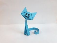 an origami cat made out of blue paper