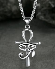 an egyptian symbol pendant on a chain with the word love written in arabic and diamond