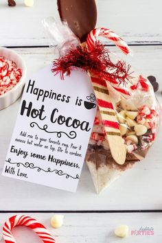 a hot cocoa bar with candy canes, marshmallows and candies