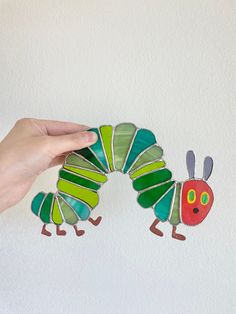 Inspired by Eric Carle's The Very Hungry Caterpillar! Stained glass sun catcher handmade art. Stained Glass Caterpillar, Hungry Caterpillar Art, Easy Stained Glass Patterns, Caterpillar Art, Stained Glass Sun, Panels Wall, Nursery Room Inspiration, Stained Glass Suncatchers, The Very Hungry Caterpillar