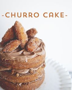 a stack of doughnuts sitting on top of a white plate with chocolate frosting