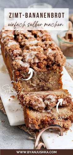 a close up of a loaf of bread on a plate with icing and cinnamon