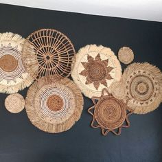 woven baskets are arranged on the wall in an artistic manner, including one with a star