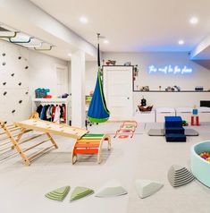 a playroom with toys and other items in the room, including a hammock