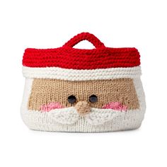 a knitted bag with a santa claus face on the front and red trimmings