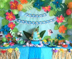 a table topped with lots of cake and balloons