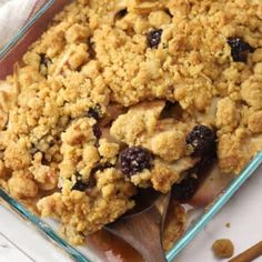 a casserole dish with blueberries and crumbled topping