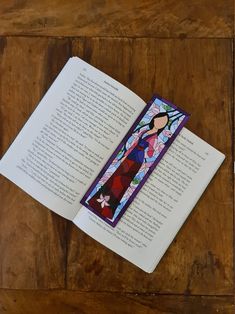 an open book sitting on top of a wooden table