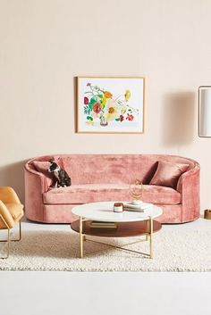 a living room filled with furniture and a painting on the wall