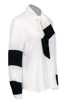 Go classic and chic with this neutral blouse by Louis Feraud! A silk blend button front boluses with color blocked sleeve details featuring black stripes. Pair with your wide leg black pants, a sleek sling back heel, and a colorful leather tote for a posh and polished everyday look! Size 4 60% Acetate, 40% Silk Button front Unlined V-neckline Long sleeve Color blocked design Tie at neckline Bust 40" Waist 40" Shoulder to hem 26" Sleeve length 24" Neutral Blouse, Wide Leg Black Pants, Neutral Blouses, Louis Feraud, Black Wide Leg Pants, Colored Leather, Sling Back, Sleeve Detail, Black Stripes