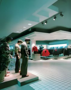 two men are looking at shirts in a clothing store with blue walls and white tiled flooring