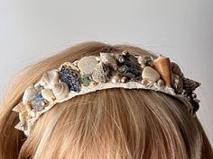 A unique and beachy headband with a lovely assortment of natural seashells and New Zealand paua abalone shells on an ivory white background, enhanced with Swarovski crystal pearls.  Perfect for a beach wedding or for the finishing touch of a mermaid costume. I've added white ribbon to the ends to make this super secure, but you can easily remove these, or change them to a different colour to match your hair as they are attached with a simple lark's head knot. Your headband weighs approximately 1 Shell Headbands, Seashell Hair Accessories, Sea Shells Hair Accessories, Sea Shell Wedding Crown, Mermaid Shell Crown, Seashells Hair Accessories, Seashell Headband, Shell Crowns, Seashell Crown