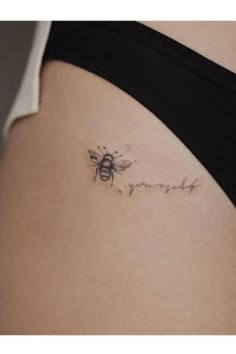 a woman's stomach with a bee tattoo on it that says, i love you