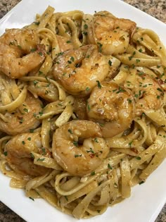 pasta with shrimp and garlic on a white plate