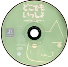 a green cd disc with an image of a cat on it's side and japanese writing