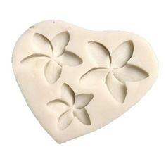 a heart shaped mold with four flowers on it