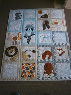 a baby quilt with animals and letters on it