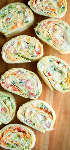 several pieces of food on a wooden surface with one cut in half and the other rolled up