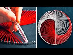 a hand holding a pair of scissors next to a piece of string art