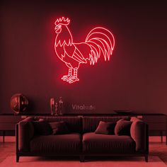 a living room with a couch and a neon rooster sign on the wall