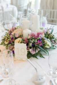 the table is set with flowers and candles