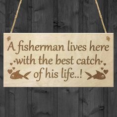 a fisherman lives here with the best catch of his life wooden sign hanging on a wall