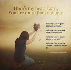 a woman kneeling down in front of a wall with a message on it that reads, here's my heart lord, you are more than enough