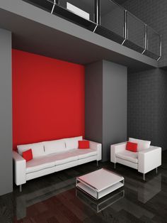 a living room with red walls and white furniture