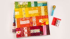 a colorful patchwork quilt and scissors on a white surface