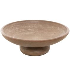 a wooden bowl sitting on top of a white surface with no one in the photo