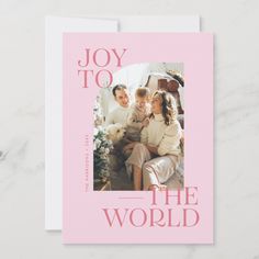 a pink card with the words joy to the world on it and an image of a family