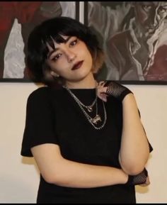 a woman in black shirt standing with her arms crossed