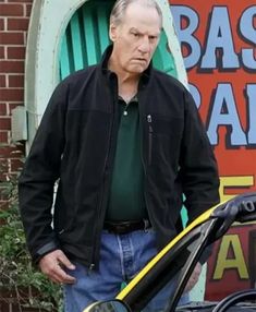 an older man standing next to a parked car