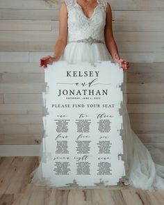 a woman in a wedding dress holding up a seating chart for a ceremony or reception