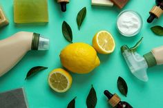 some lemons are sitting on a table next to bottles and other items that include toothpaste