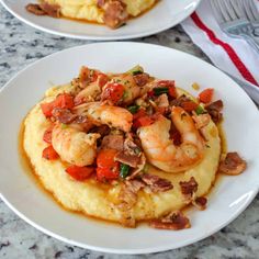 two white plates topped with shrimp and grits