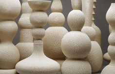 a group of white vases sitting next to each other