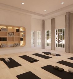 a yoga room with black mats and white walls