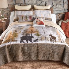 a bed with a bear and deer design on the comforter is shown in front of a stone wall